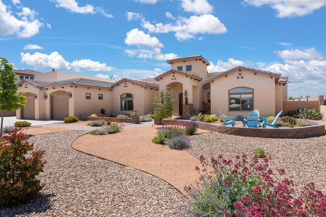 2633 Globe Ct NE, Rio Rancho, NM 87124 - mediterranean / spanish-style house with stucco siding, an attached garage, and driveway