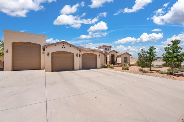2633 Globe Ct NE, Rio Rancho, NM 87124 - mediterranean / spanish-style house featuring driveway, a garage, and stucco siding