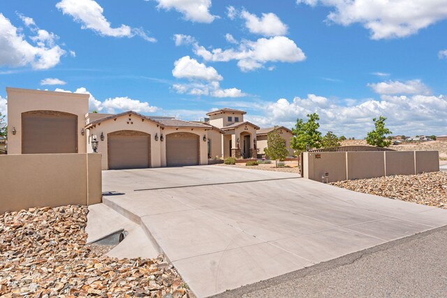 2633 Globe Ct NE, Rio Rancho, NM 87124 - view of front of home with driveway, an attached garage, and stucco siding