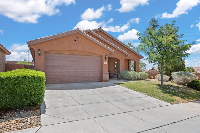 429 Paseo Vista Loop NE, Rio Rancho, NM 87124 - mediterranean / spanish-style home with concrete driveway, a garage, stucco siding, and a front yard