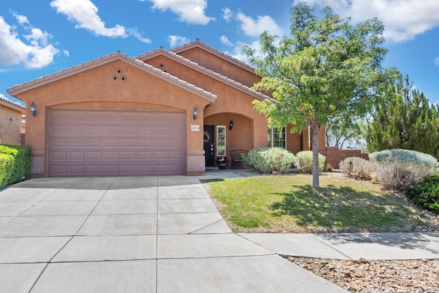 429 Paseo Vista Loop NE, Rio Rancho, NM 87124 - mediterranean / spanish-style house with stucco siding, an attached garage, driveway, and a tile roof
