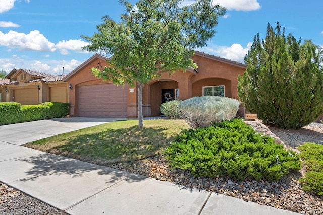 429 Paseo Vista Loop NE, Rio Rancho, NM 87124 - mediterranean / spanish-style home with an attached garage, stucco siding, concrete driveway, and a tile roof