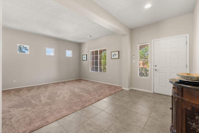 429 Paseo Vista Loop NE, Rio Rancho, NM 87124 - entryway featuring healthy amount of natural light, light carpet, baseboards, recessed lighting, and a textured ceiling