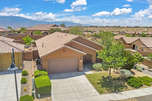 429 Paseo Vista Loop NE, Rio Rancho, NM 87124 - view of front of property with driveway, a mountain view, a residential view, a garage, and a tiled roof