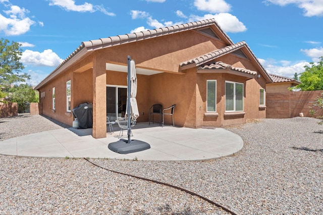 429 Paseo Vista Loop NE, Rio Rancho, NM 87124 - back of house with stucco siding, a tile roof, and a patio