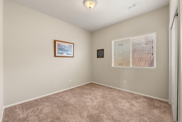 429 Paseo Vista Loop NE, Rio Rancho, NM 87124 - carpeted spare room featuring baseboards and a textured ceiling