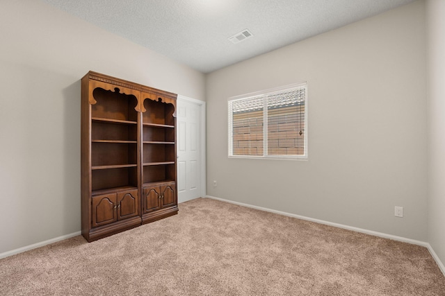 429 Paseo Vista Loop NE, Rio Rancho, NM 87124 - unfurnished room featuring light carpet, baseboards, and a textured ceiling