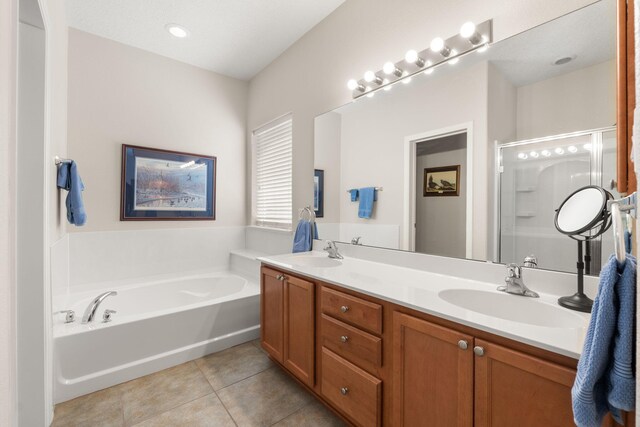 429 Paseo Vista Loop NE, Rio Rancho, NM 87124 - full bathroom featuring tile patterned floors, double vanity, a bath, and a shower stall