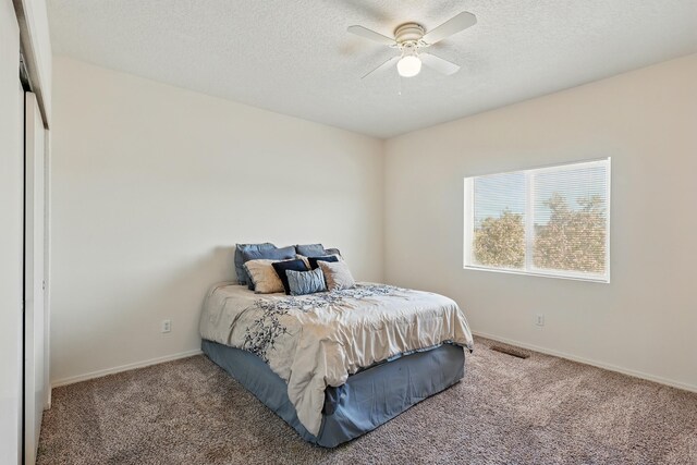 10016 Rio Canon Ave SW, Albuquerque, NM 87121 - bedroom featuring carpet, a textured ceiling, and ceiling fan