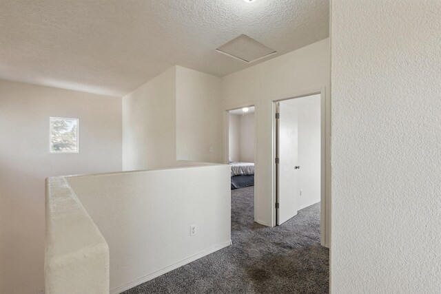 10016 Rio Canon Ave SW, Albuquerque, NM 87121 - corridor featuring carpet floors, a textured ceiling, an upstairs landing, and attic access