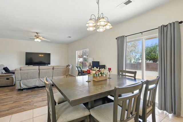 10016 Rio Canon Ave SW, Albuquerque, NM 87121 - dining space featuring light tile patterned floors, a chandelier, and a ceiling fan