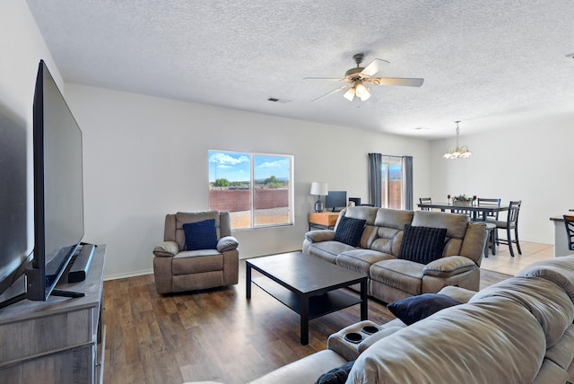 10016 Rio Canon Ave SW, Albuquerque, NM 87121 - living area featuring a ceiling fan, a chandelier, wood finished floors, and a textured ceiling