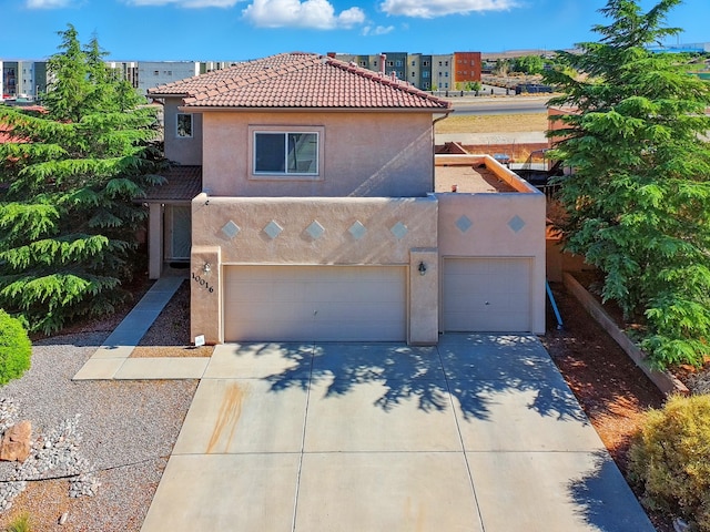 10016 Rio Canon Ave SW, Albuquerque, NM 87121 - view of front of home featuring stucco siding, driveway, an attached garage, and a tiled roof