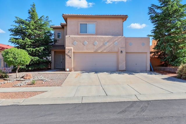10016 Rio Canon Ave SW, Albuquerque, NM 87121 - view of front of property with stucco siding, concrete driveway, a tiled roof, and a garage