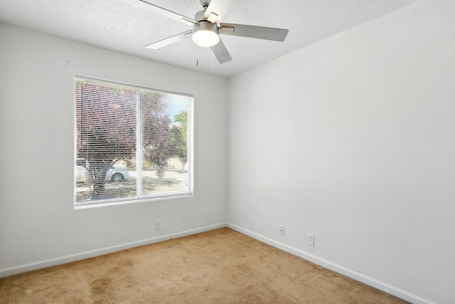 5940 Night Rose Ave NW, Albuquerque, NM 87114 - spare room with light colored carpet, baseboards, ceiling fan, and a textured ceiling