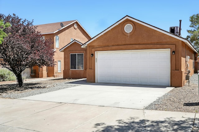 5940 Night Rose Ave NW, Albuquerque, NM 87114 - view of front facade with concrete driveway, an attached garage, and stucco siding