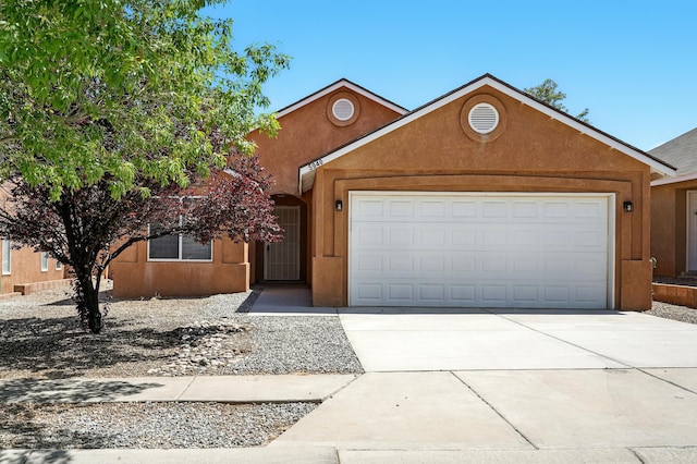 5940 Night Rose Ave NW, Albuquerque, NM 87114 - view of front of home with an attached garage, concrete driveway, and stucco siding