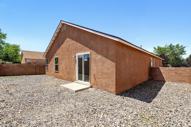 5940 Night Rose Ave NW, Albuquerque, NM 87114 - rear view of house featuring stucco siding and a fenced backyard