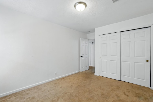 5940 Night Rose Ave NW, Albuquerque, NM 87114 - unfurnished bedroom featuring carpet flooring, baseboards, a closet, and a textured ceiling