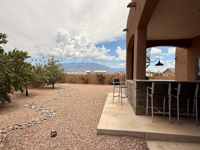 3220 Vatapa Rd NE, Rio Rancho, NM 87144 - fenced backyard with a mountain view and a patio area