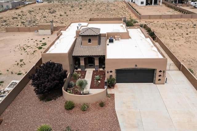3220 Vatapa Rd NE, Rio Rancho, NM 87144 - view of front of property featuring stucco siding, a garage, a tiled roof, and driveway