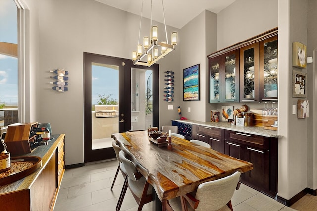 3220 Vatapa Rd NE, Rio Rancho, NM 87144 - dining room featuring a chandelier, baseboards, and light tile patterned flooring