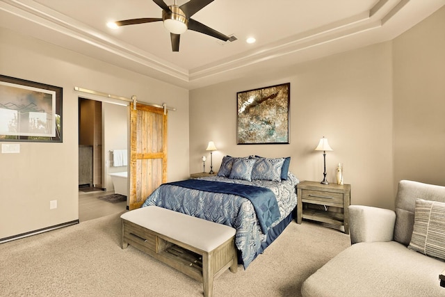 3220 Vatapa Rd NE, Rio Rancho, NM 87144 - bedroom with a raised ceiling, carpet flooring, a barn door, connected bathroom, and recessed lighting