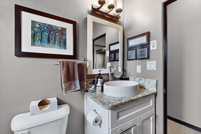 3220 Vatapa Rd NE, Rio Rancho, NM 87144 - bathroom featuring toilet, vanity, and baseboards