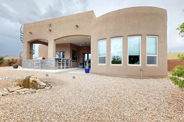 3220 Vatapa Rd NE, Rio Rancho, NM 87144 - back of property featuring stucco siding and a patio