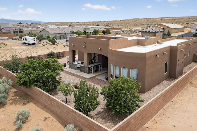 3220 Vatapa Rd NE, Rio Rancho, NM 87144 - back of property featuring stucco siding, a mountain view, a residential view, and a patio