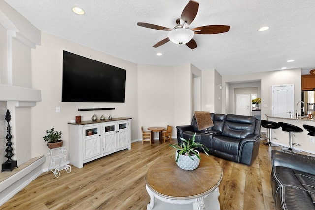1720 Summer Breeze Dr NW, Albuquerque, NM 87120 - living room featuring a ceiling fan, light wood-type flooring, a textured ceiling, and recessed lighting