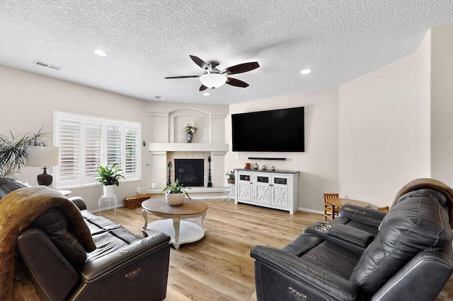 1720 Summer Breeze Dr NW, Albuquerque, NM 87120 - living area with ceiling fan, recessed lighting, a fireplace, light wood-style floors, and a textured ceiling