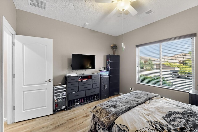 1720 Summer Breeze Dr NW, Albuquerque, NM 87120 - bedroom with light wood-type flooring, a textured ceiling, and a ceiling fan