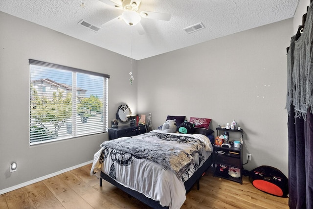 1720 Summer Breeze Dr NW, Albuquerque, NM 87120 - bedroom with wood finished floors, a textured ceiling, and a ceiling fan