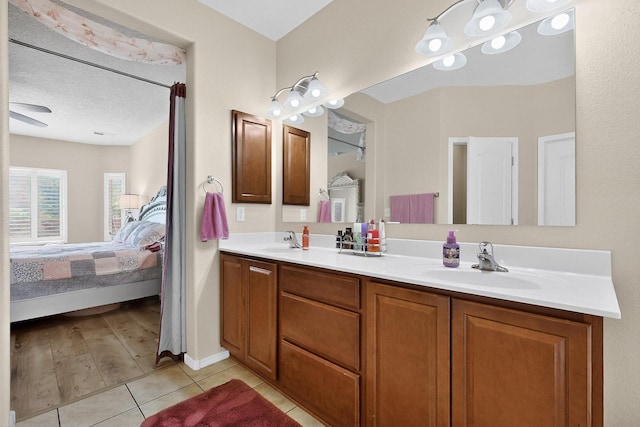 1720 Summer Breeze Dr NW, Albuquerque, NM 87120 - ensuite bathroom featuring double vanity and tile patterned flooring
