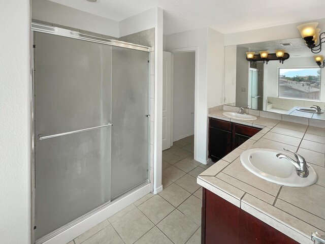 10909 Estribo St NW, Albuquerque, NM 87114 - full bathroom featuring vanity, tile patterned floors, and a stall shower