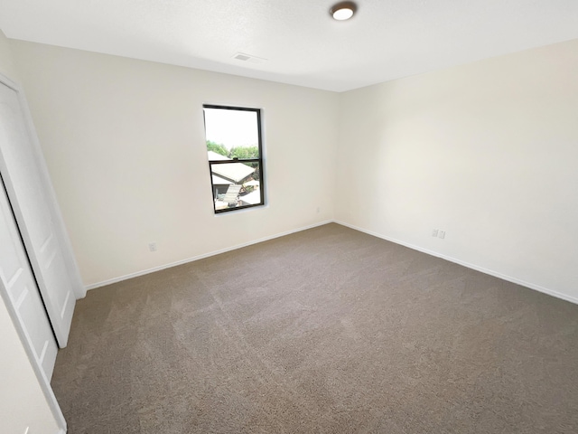 10909 Estribo St NW, Albuquerque, NM 87114 - unfurnished room featuring dark carpet and baseboards