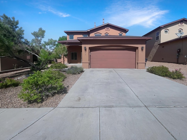 10909 Estribo St NW, Albuquerque, NM 87114 - view of front of home with concrete driveway, stucco siding, and a garage
