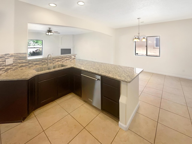 10909 Estribo St NW, Albuquerque, NM 87114 - kitchen featuring a sink, dishwasher, light tile patterned floors, light stone countertops, and recessed lighting