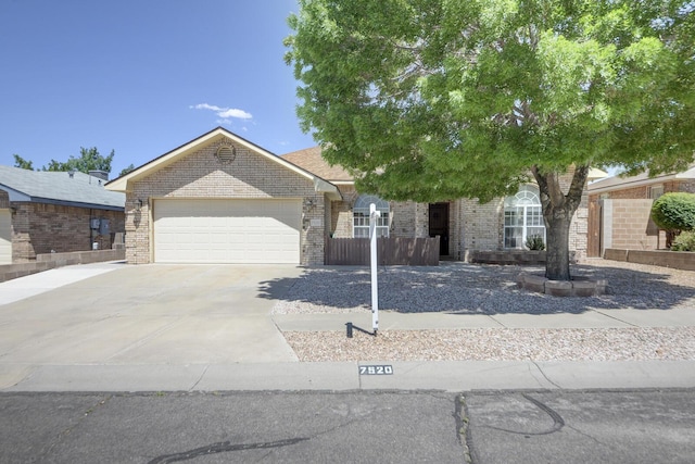 7520 Rosette Dr NW, Albuquerque, NM 87120 - view of front of home with concrete driveway, a garage, and brick siding