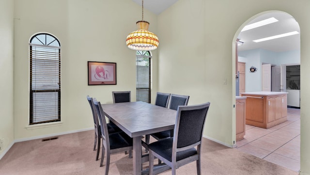 11041 Academy Ridge Rd NE, Albuquerque, NM 87111 - dining space featuring arched walkways, light carpet, healthy amount of natural light, and high vaulted ceiling