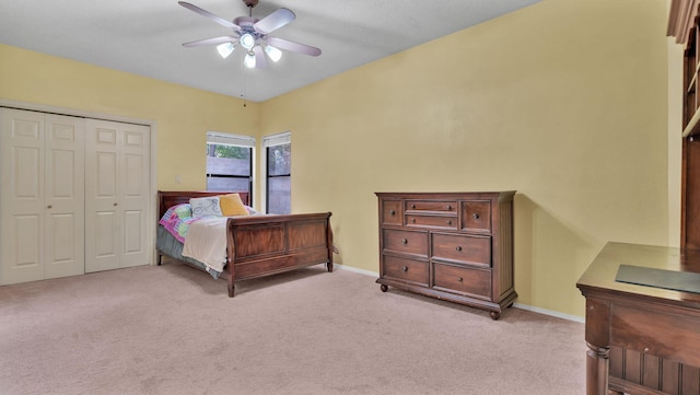 11041 Academy Ridge Rd NE, Albuquerque, NM 87111 - bedroom with light carpet, a closet, baseboards, and a ceiling fan