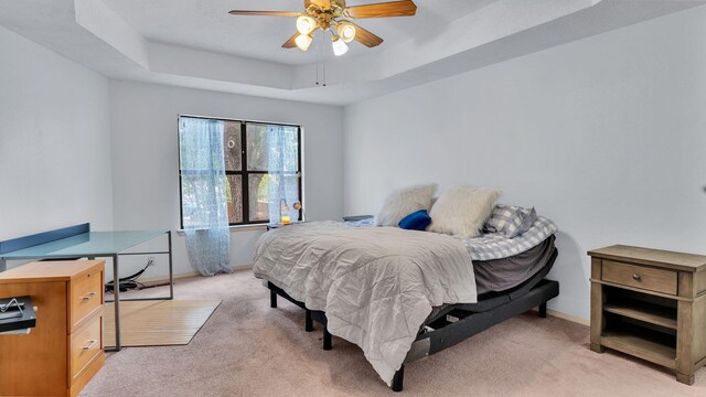 11041 Academy Ridge Rd NE, Albuquerque, NM 87111 - bedroom featuring light carpet, a raised ceiling, baseboards, and a ceiling fan