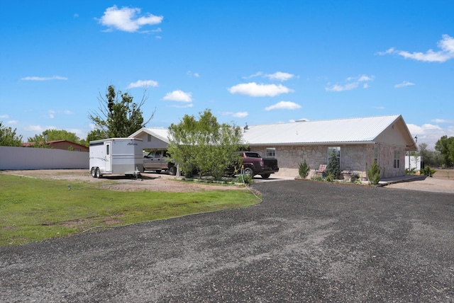 185 La Entrada Rd, Los Lunas, NM 87031 - view of front of home with a metal roof and stone siding