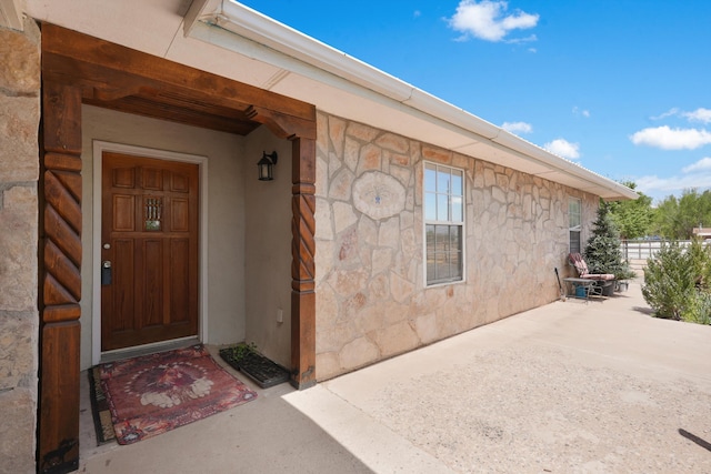 185 La Entrada Rd, Los Lunas, NM 87031 - view of exterior entry featuring stone siding and a patio area