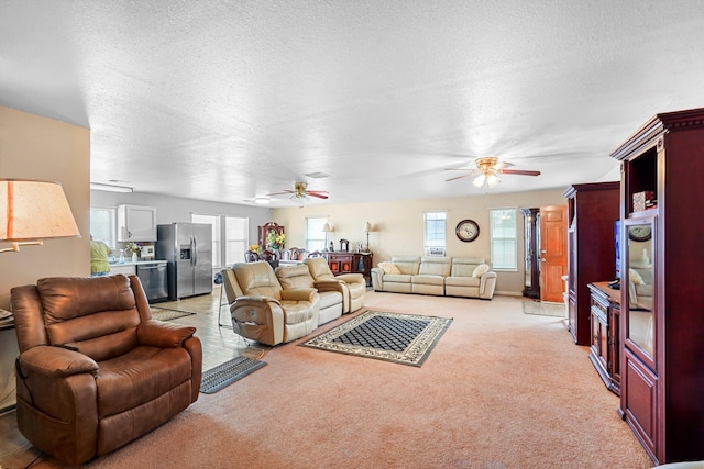 185 La Entrada Rd, Los Lunas, NM 87031 - living area with ceiling fan, healthy amount of natural light, light carpet, and a textured ceiling