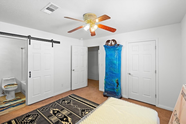 185 La Entrada Rd, Los Lunas, NM 87031 - bedroom featuring carpet floors, a barn door, and ceiling fan