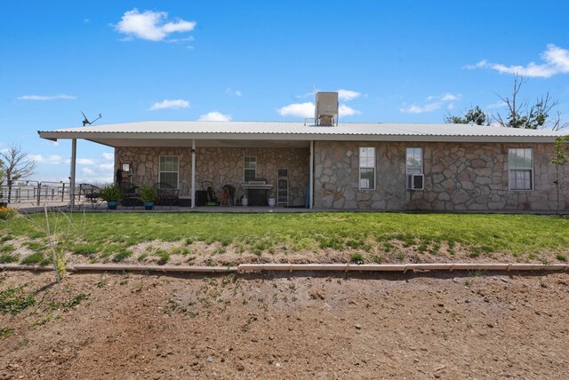 185 La Entrada Rd, Los Lunas, NM 87031 - back of property featuring stone siding, cooling unit, and a patio area