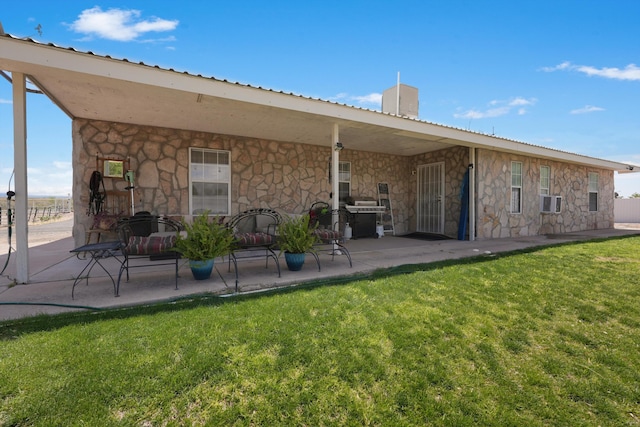 185 La Entrada Rd, Los Lunas, NM 87031 - back of property with stone siding, a yard, a patio, cooling unit, and a metal roof