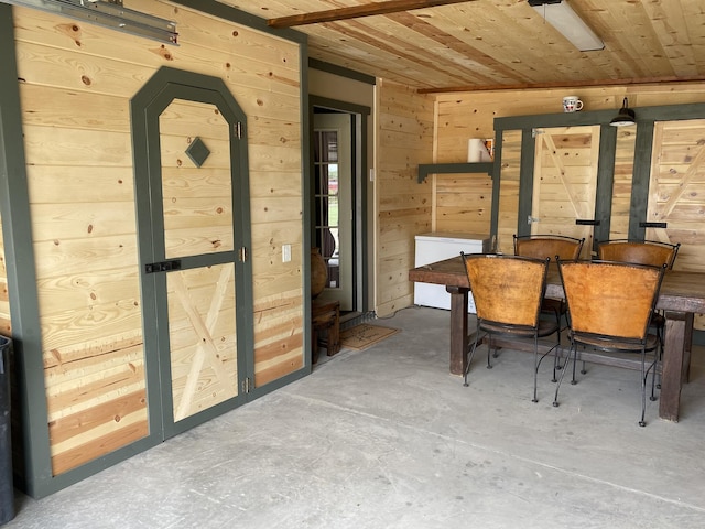 10 Berkshire Rd, Estancia, NM 87016 - dining room featuring wooden walls, unfinished concrete flooring, and wooden ceiling